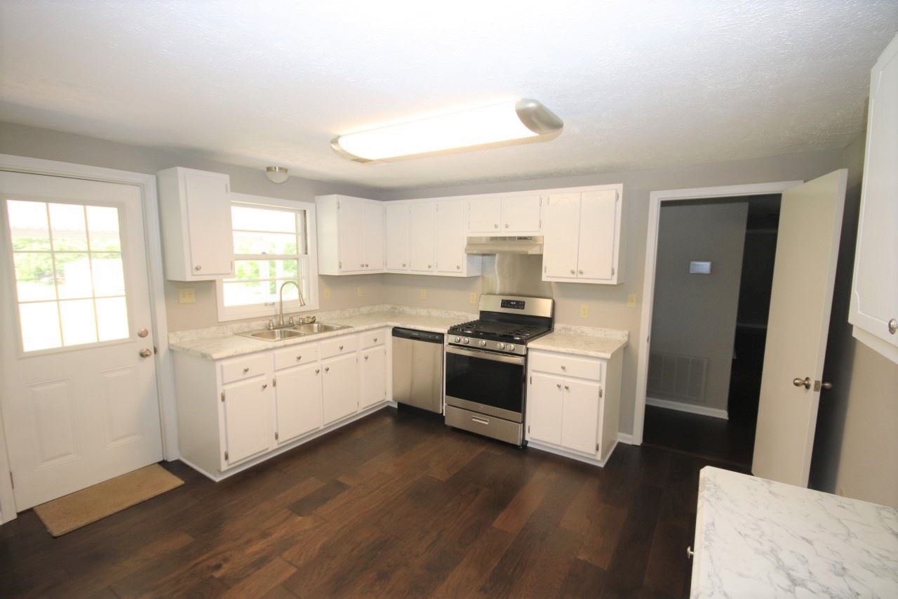 1419 Hurricane Hill Road Ripley, TN 38063 - Photo 8 of 21 a kitchen with granite countertop white cabinets and white appliances