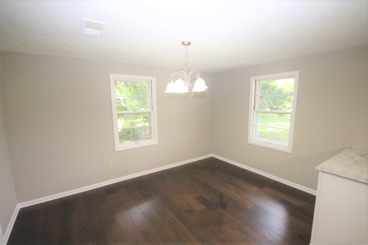 1419 Hurricane Hill Road Ripley, TN 38063 - Photo 10 of 21 a view of an empty room with wooden floor and a window
