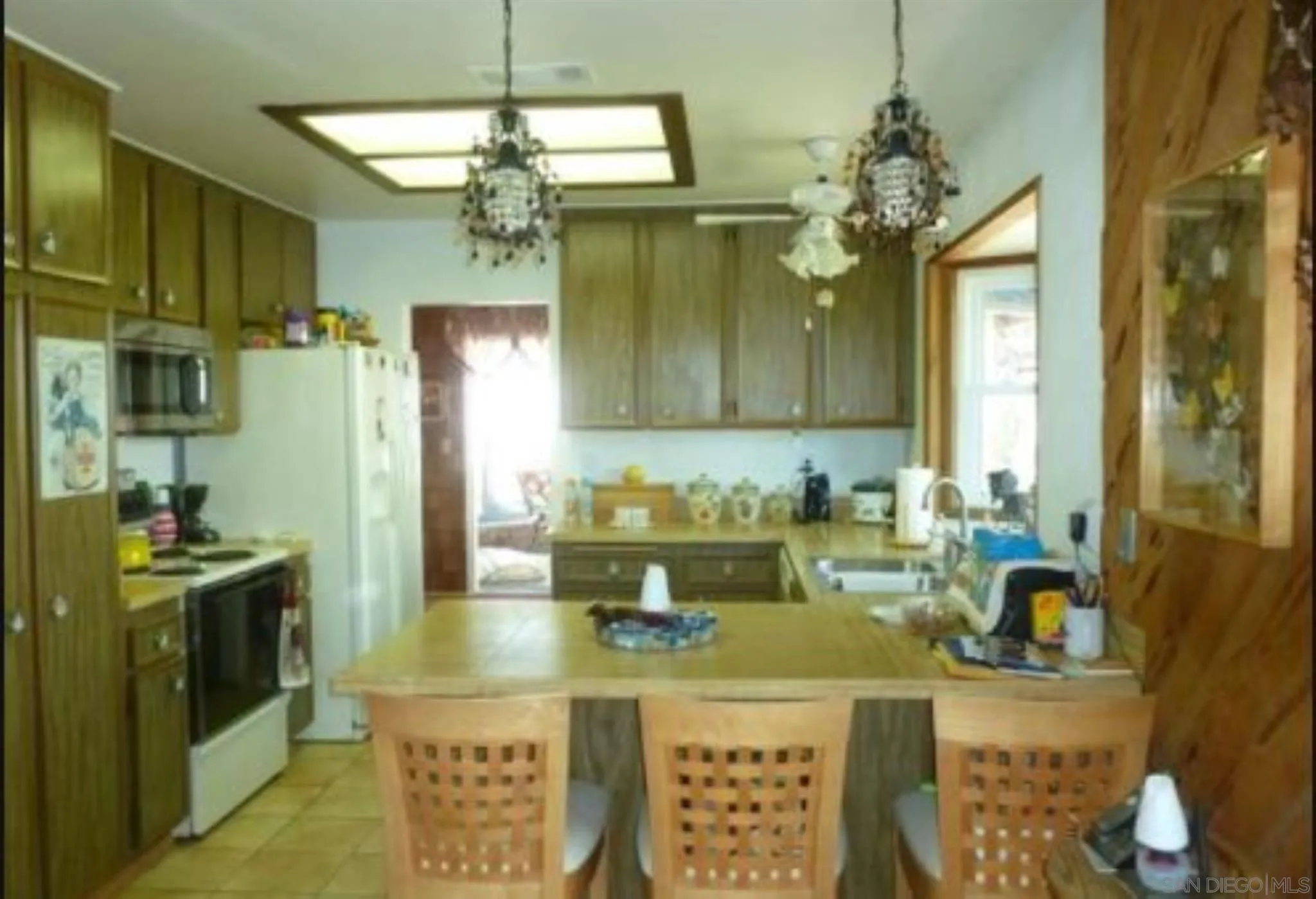 9934 Ivy Street Spring Valley, CA 91977 - Photo 7 of 12 a kitchen with a stove a sink and cabinets