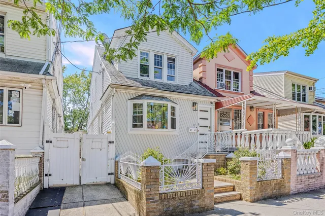 a front view of house with a garden
