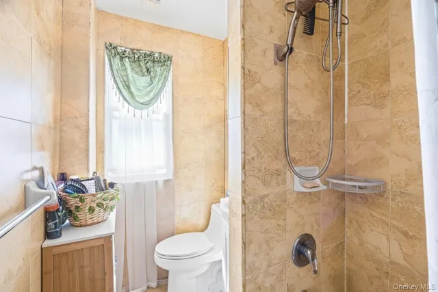 a bathroom with a toilet sink and shower