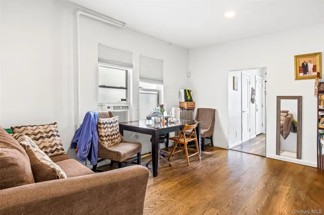 a living room with furniture wooden floor and a table