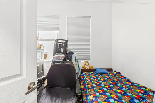 a bedroom with a bed and a lamp next to a window