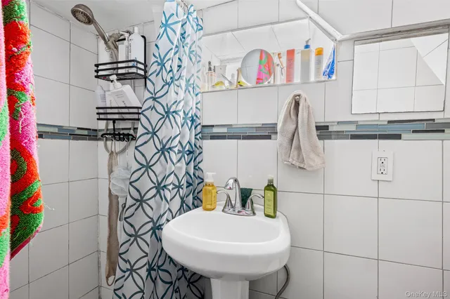 a bathroom with a sink a mirror and shower