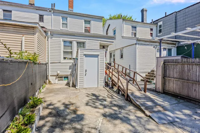 a view of a house with wooden fence