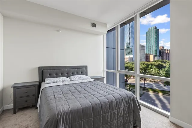 a bed sitting in a bedroom next to a window