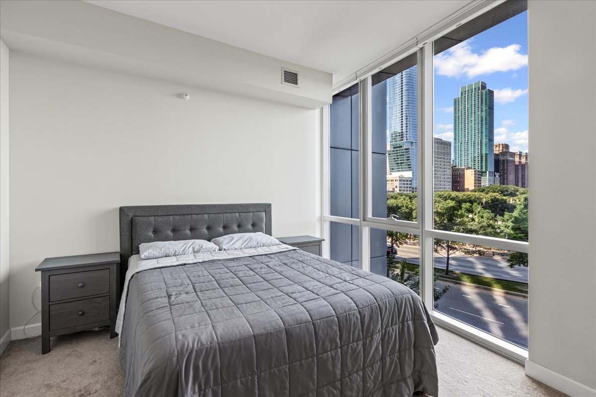 1201 South Prairie Avenue, Unit 403 Chicago, IL 60605 - Photo 11 of 23 a bed sitting in a bedroom next to a window