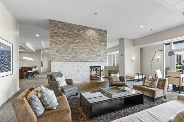 a living room with furniture and kitchen view