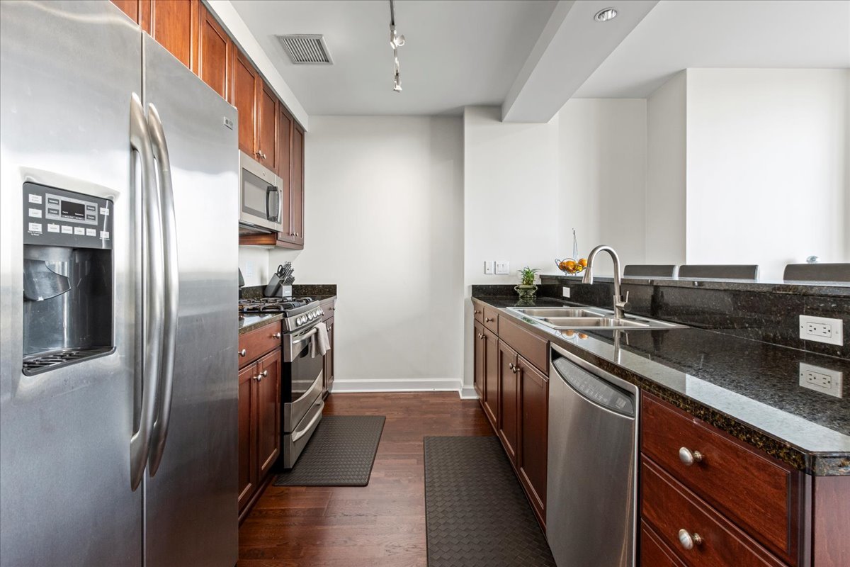 1201 South Prairie Avenue, Unit 403 Chicago, IL 60605 - Photo 6 of 23 a kitchen with stainless steel appliances granite countertop a refrigerator and a sink