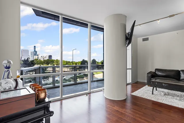 an outdoor living room with furniture and a floor to ceiling window