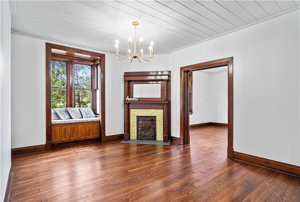 650 Hood School Road Indiana, PA 15701 - Photo 15 of 47 an empty room with wooden floor fireplace and windows