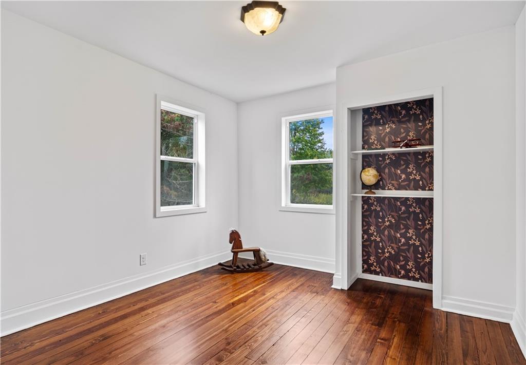 650 Hood School Road Indiana, PA 15701 - Photo 26 of 47 an empty room with wooden floor and windows