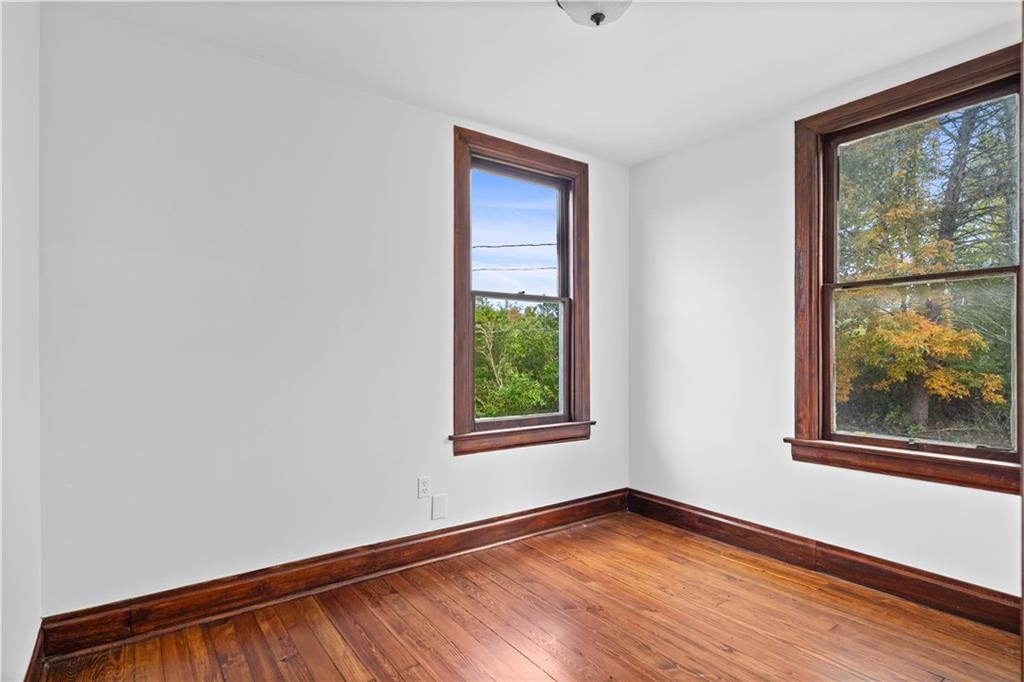 650 Hood School Road Indiana, PA 15701 - Photo 27 of 47 an empty room with wooden floor and windows