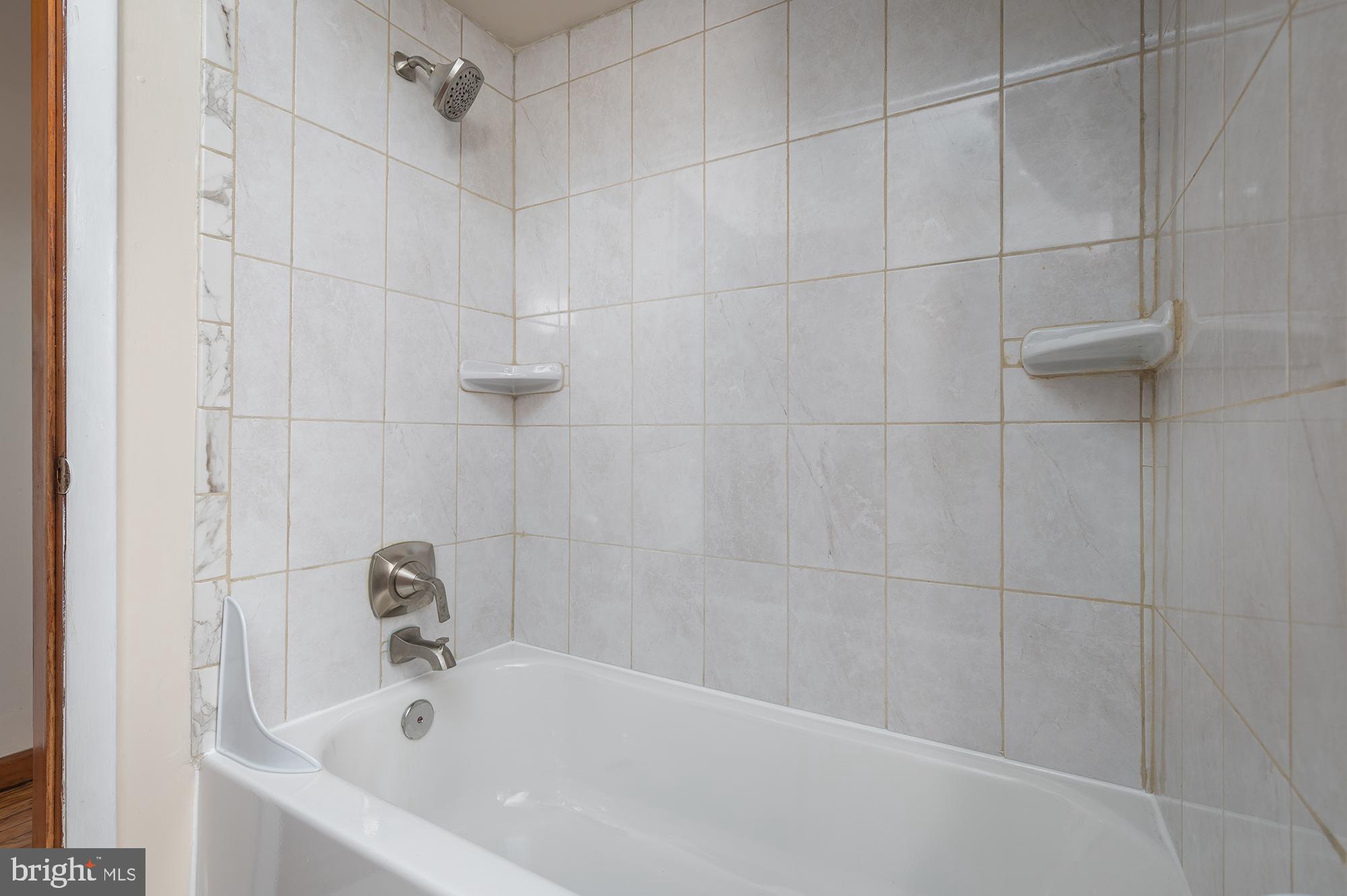 1726 Leslie Road Dundalk, MD 21222 - Photo 13 of 28 a white bath tub sitting in a bathroom