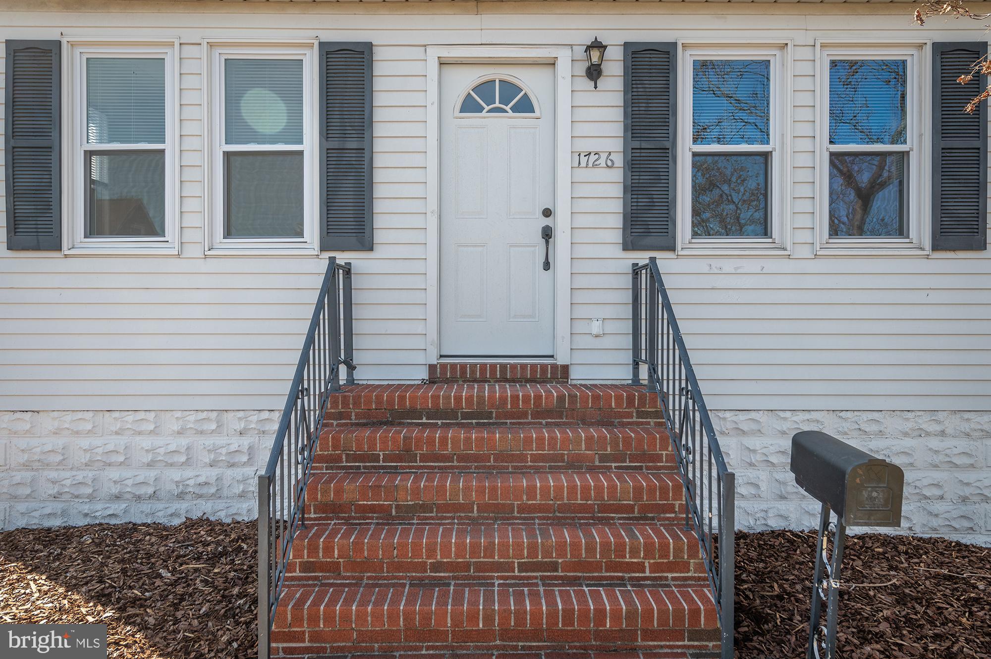1726 Leslie Road Dundalk, MD 21222 - Photo 4 of 28 a front view of a house with a yard