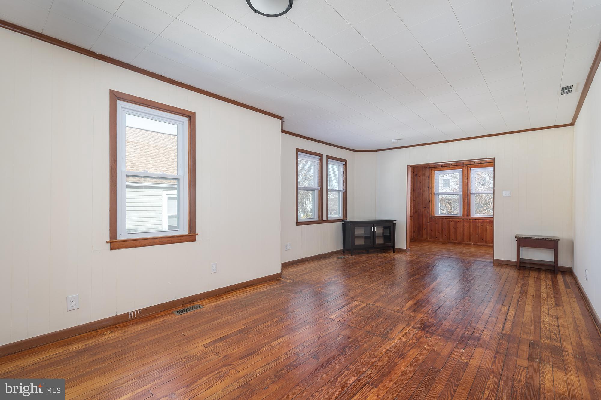 1726 Leslie Road Dundalk, MD 21222 - Photo 6 of 28 an empty room with wooden floor and windows
