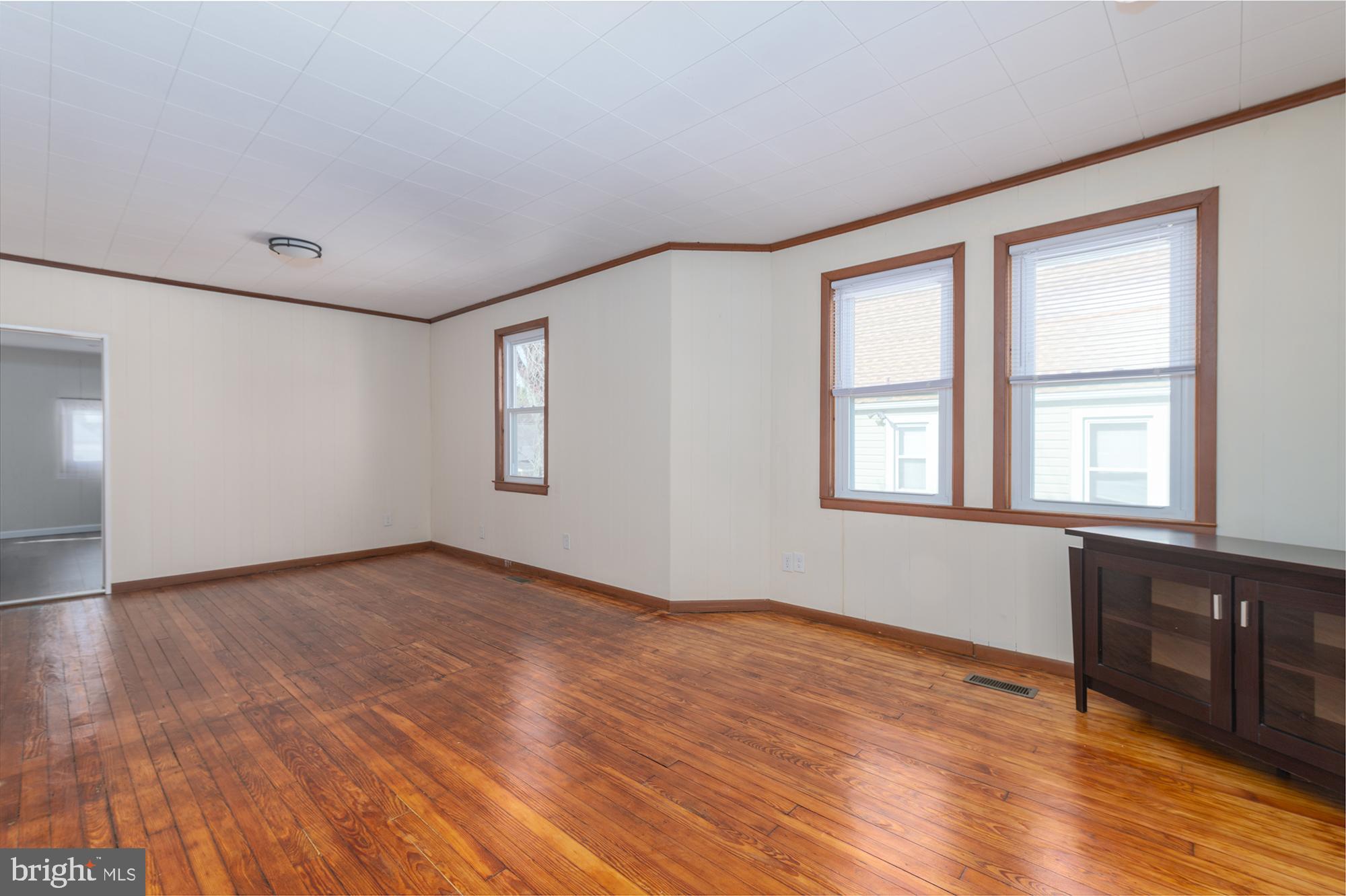 1726 Leslie Road Dundalk, MD 21222 - Photo 28 of 28 a view of an empty room with wooden floor and a window