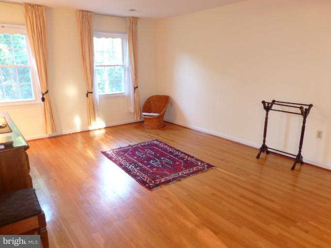 8224 Riverside Road Alexandria, VA 22308 - Photo 14 of 16 a view of an empty room with window and wooden floor