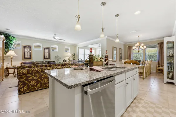 a kitchen with stainless steel appliances granite countertop white cabinets a sink and dishwasher