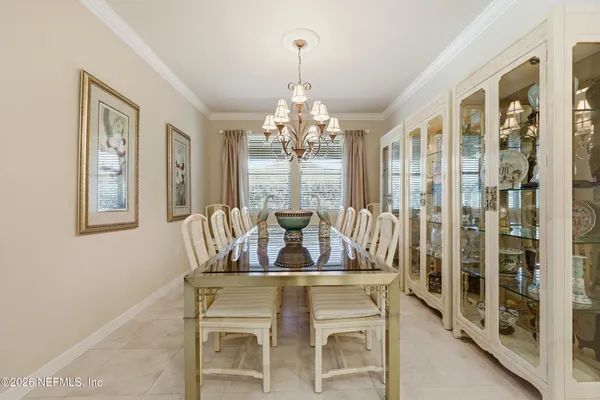 a view of a dining room with furniture and windows