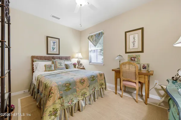 a bedroom with a bed and a table