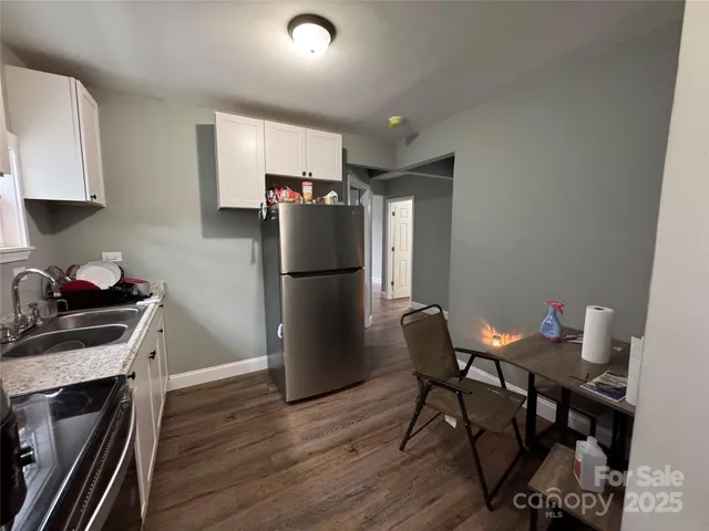 a kitchen with stainless steel appliances a refrigerator a stove a sink and a island