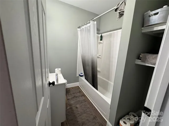 a bathroom with a glass door shower
