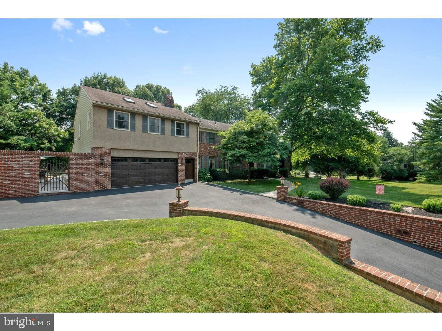 796 Worthington Road Wayne, PA 19087 - Photo 2 of 25 a front view of a house with a yard and garage