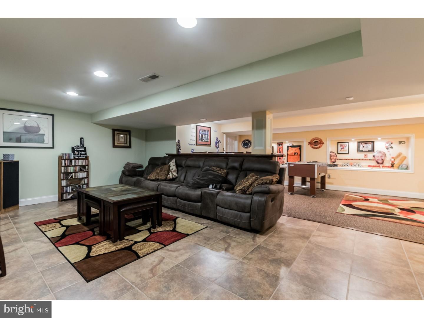 796 Worthington Road Wayne, PA 19087 - Photo 19 of 25 a living room with furniture a table and a flat screen tv