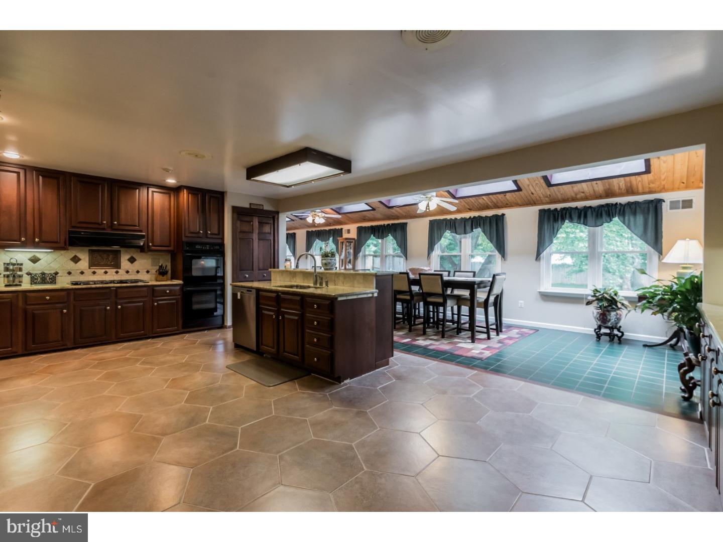 796 Worthington Road Wayne, PA 19087 - Photo 8 of 25 a large kitchen with a large counter top stainless steel appliances and cabinets