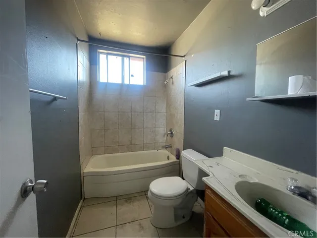 a front view of a house with garden and parking