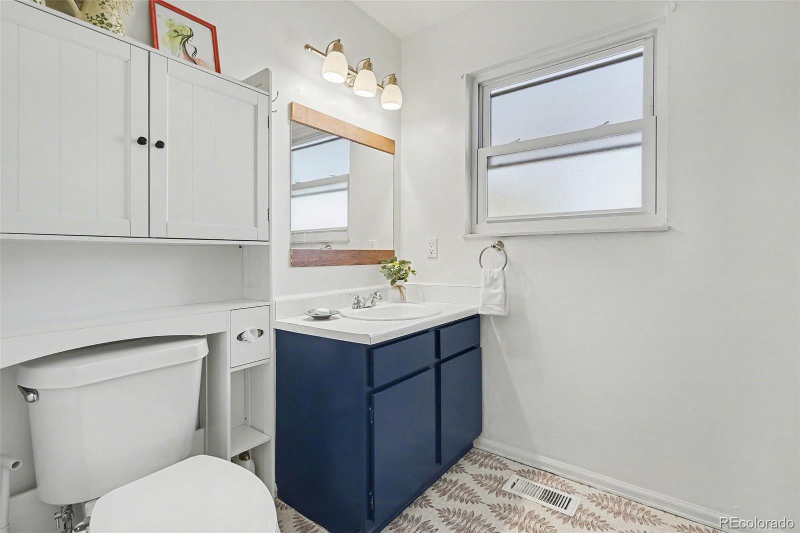 1632 South Rifle Street Aurora, CO 80017 - Photo 11 of 22 a bathroom with a sink toilet and vanity