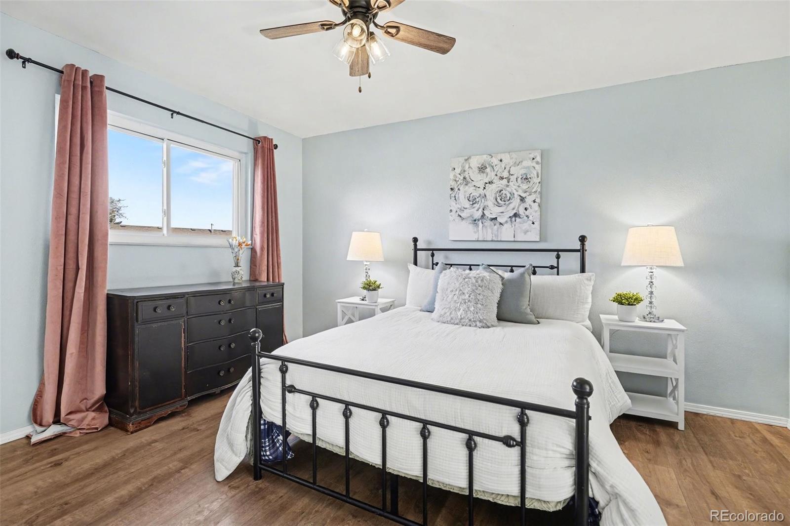 1632 South Rifle Street Aurora, CO 80017 - Photo 14 of 22 a bedroom with a bed and a chandelier