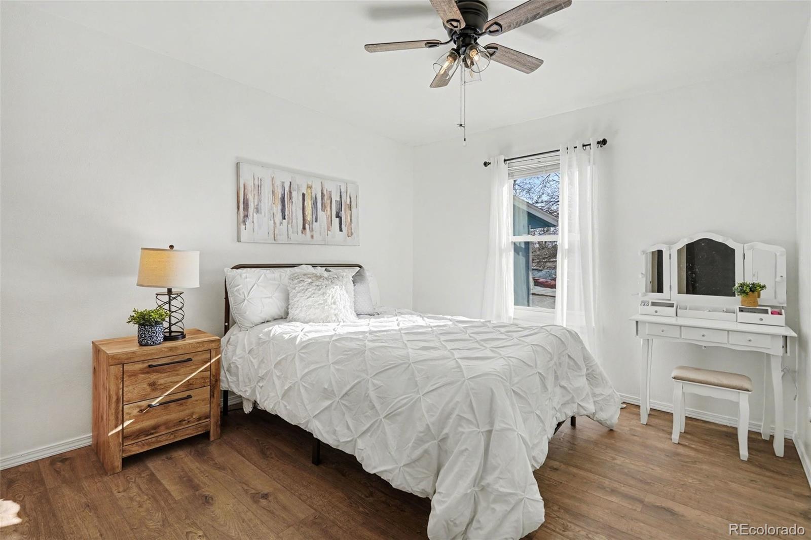 1632 South Rifle Street Aurora, CO 80017 - Photo 16 of 22 a bedroom with a bed and a table