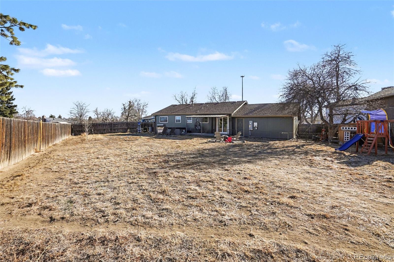 1632 South Rifle Street Aurora, CO 80017 - Photo 18 of 22 a view of house with outdoor space and trees in the background
