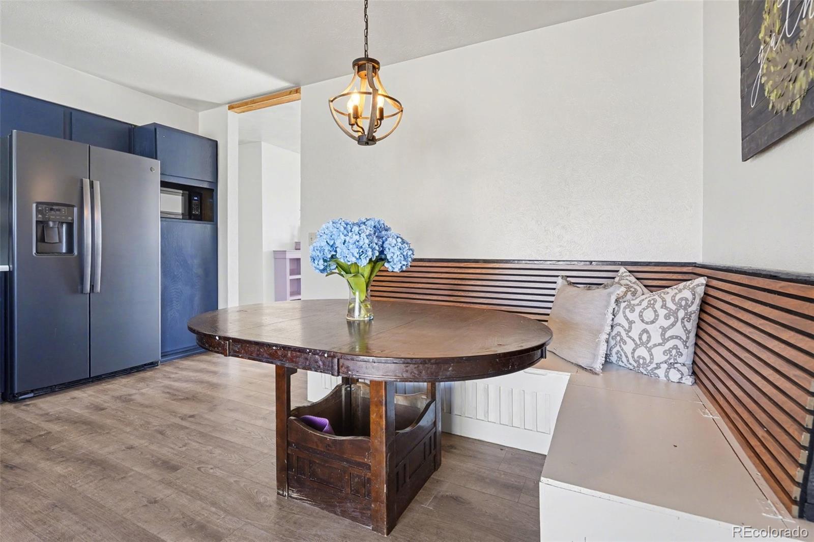 1632 South Rifle Street Aurora, CO 80017 - Photo 7 of 22 a view of a dining room with furniture and wooden floor
