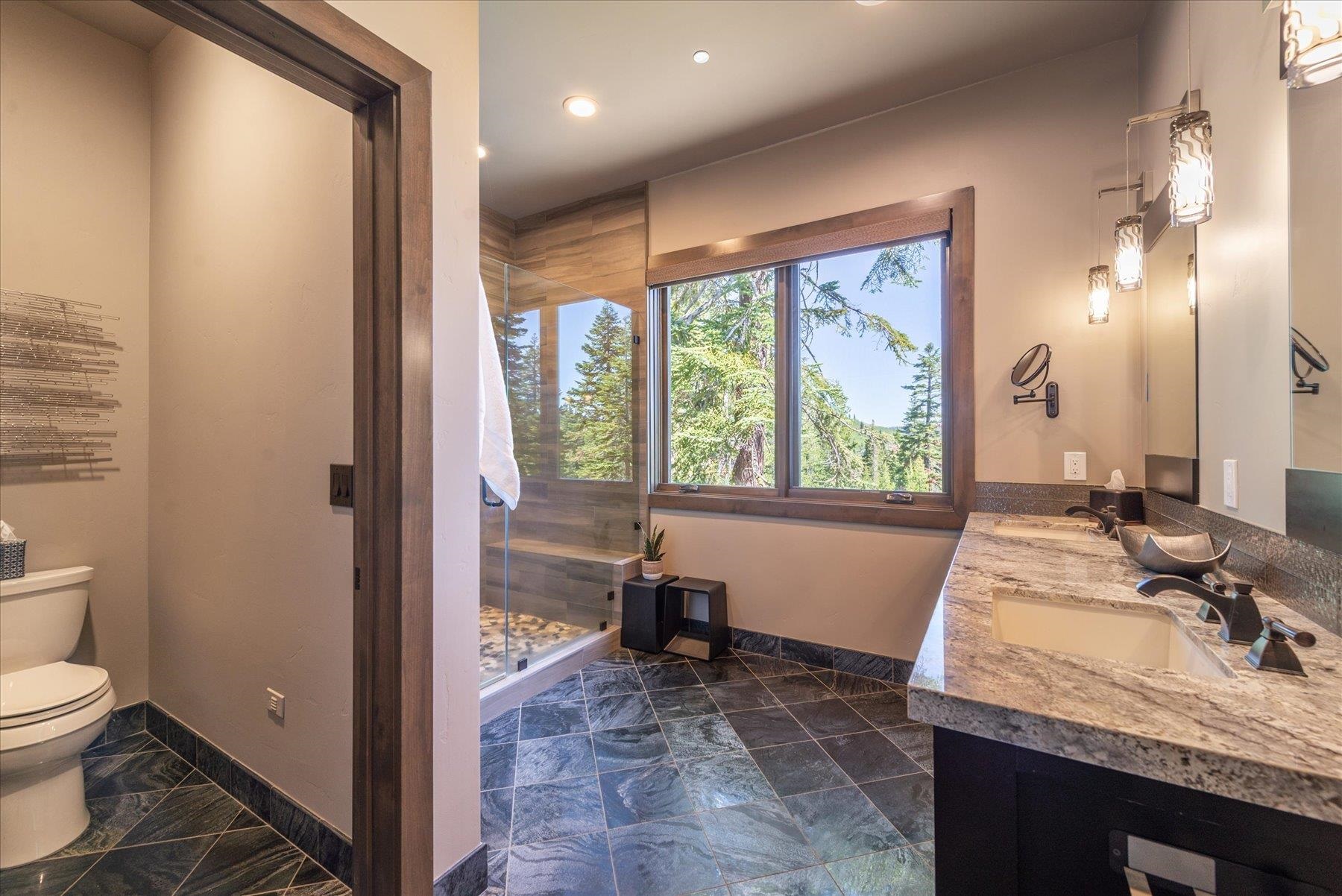 15339 Ski Slope Way Truckee, CA 96161 - Photo 13 of 28 a bathroom with a granite countertop sink a toilet and a large mirror