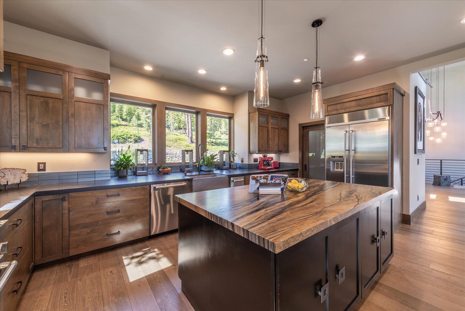 15339 Ski Slope Way Truckee, CA 96161 - Photo 10 of 28 a kitchen with granite countertop kitchen island granite countertop a stove a sink dishwasher and cabinets with wooden floor