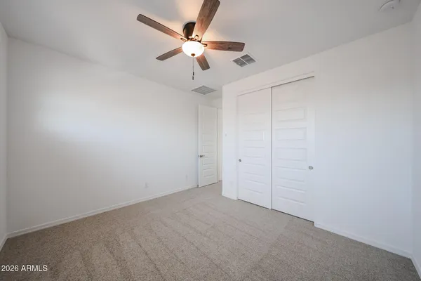 an empty room with a ceiling fan and a ceiling fan