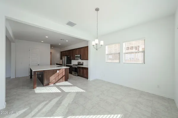 a view of kitchen with stainless steel appliances granite countertop cabinets and window