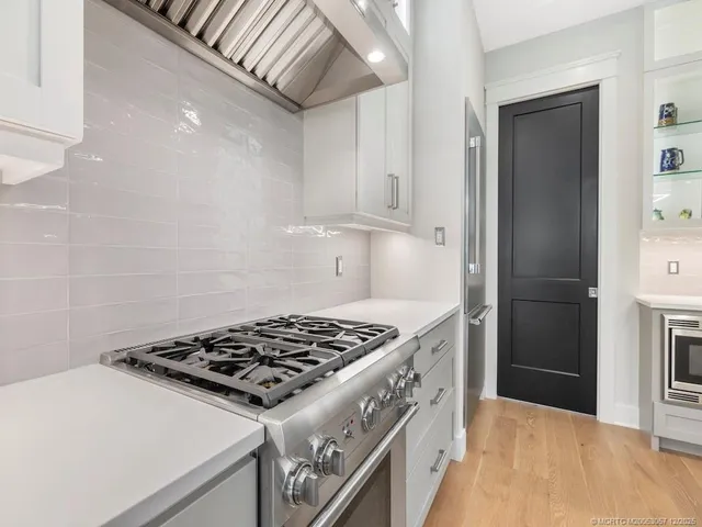 a kitchen with a stove and a refrigerator