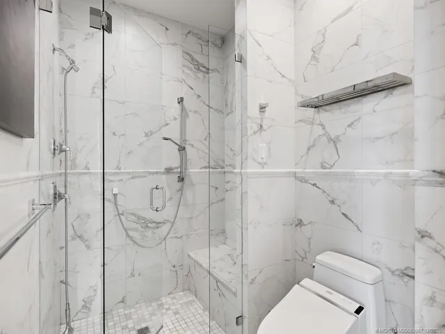 a bathroom with a toilet and shower