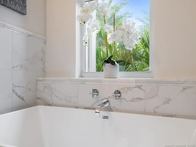 a bath tub sitting in a bathroom next to a window
