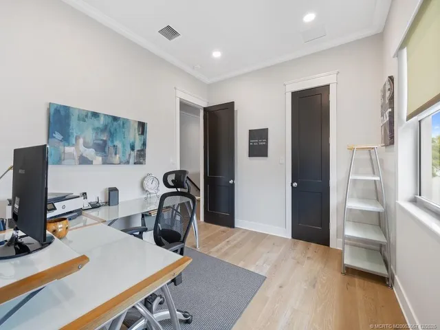 a view of a workspace with furniture and bathroom