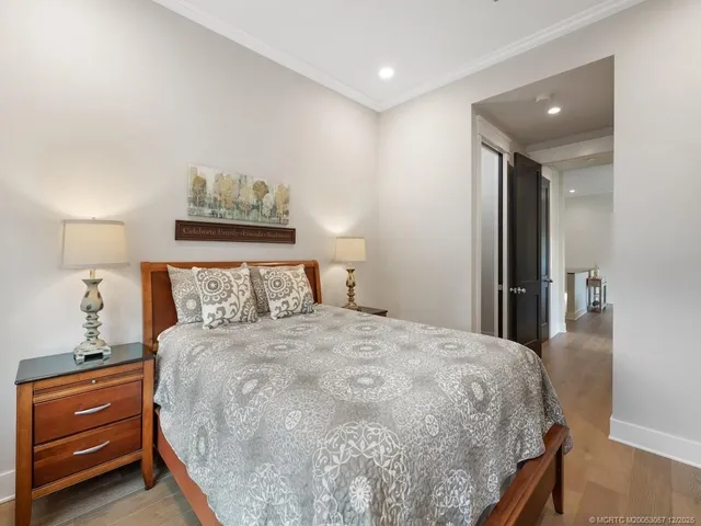 a bedroom with a bed and a lamp on dresser