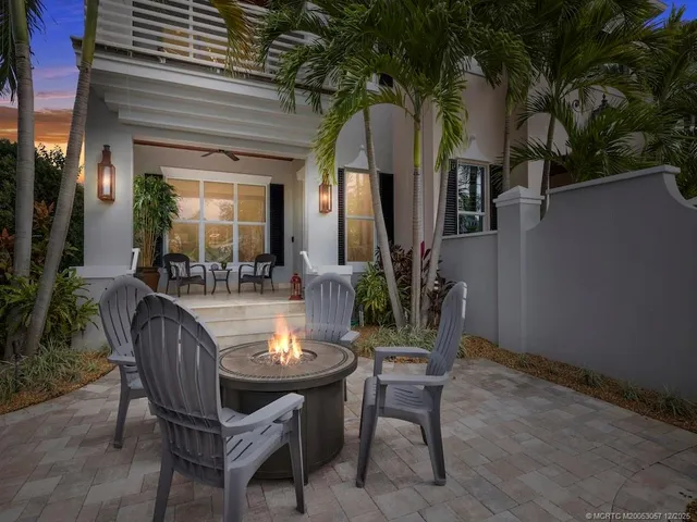 a dining room with furniture and a potted plant