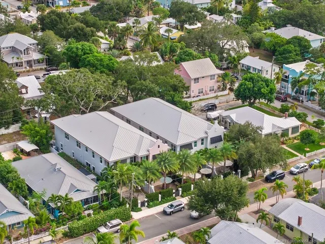 an aerial view of multiple houses with yard