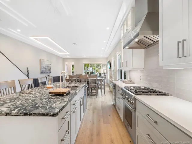 a kitchen with stainless steel appliances granite countertop a stove and a sink