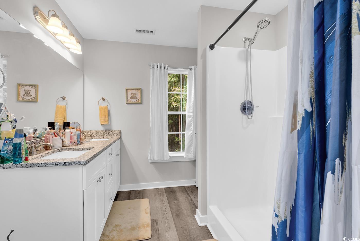 1517 Ackerrose Drive Conway, SC 29527 - Photo 14 of 33 Full bath with a shower stall, double vanity, and light wood-type flooring