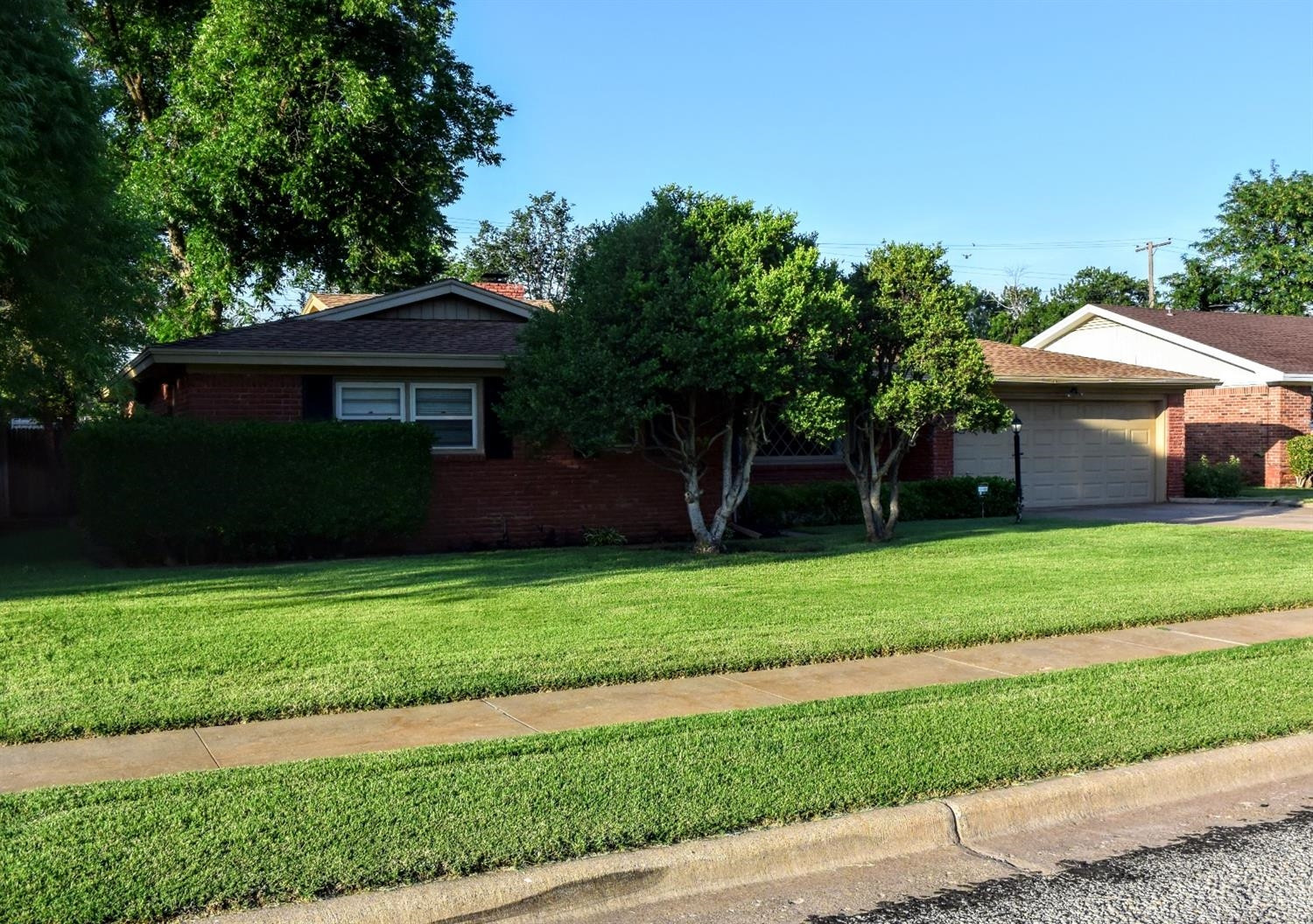 2127 52nd Street Lubbock, TX 79412 - Photo 1 of 10 a front view of a house with a garden